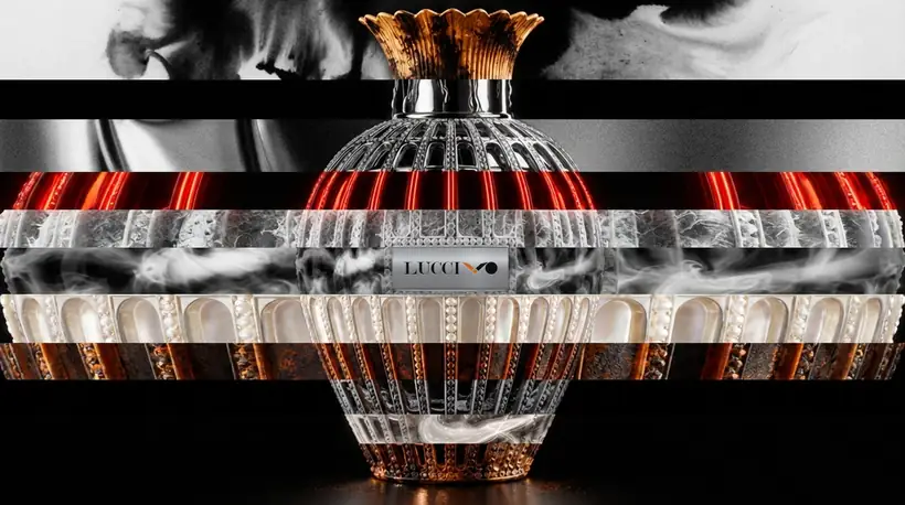 A crystal-studded flacon sliced into horizontal bands, each a different texture: a monochrome face, red neon, smoke, pearl and rusted metal, on black.